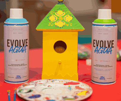 Yellow Wooden Bird House with two cans of paint and a paint pallet