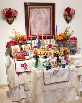Day of the Dead Traditional Ofrenda with flowers, candles and sugar skulls