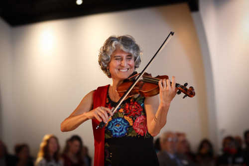 Dinorah playing her violin